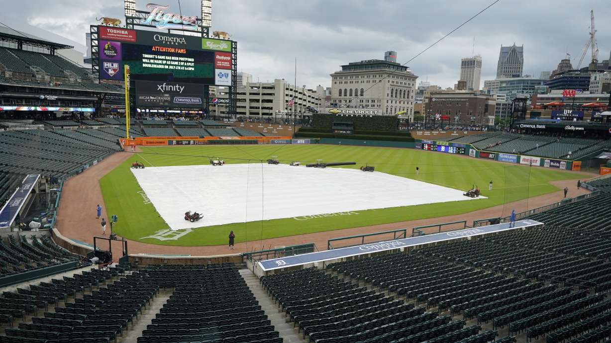 The Comerica Park infield is covered prior to the baseball game between the Detroit Tigers and the Cleveland Guardians was postponed because of rain, Friday, May 27, 2022, in Detroit.