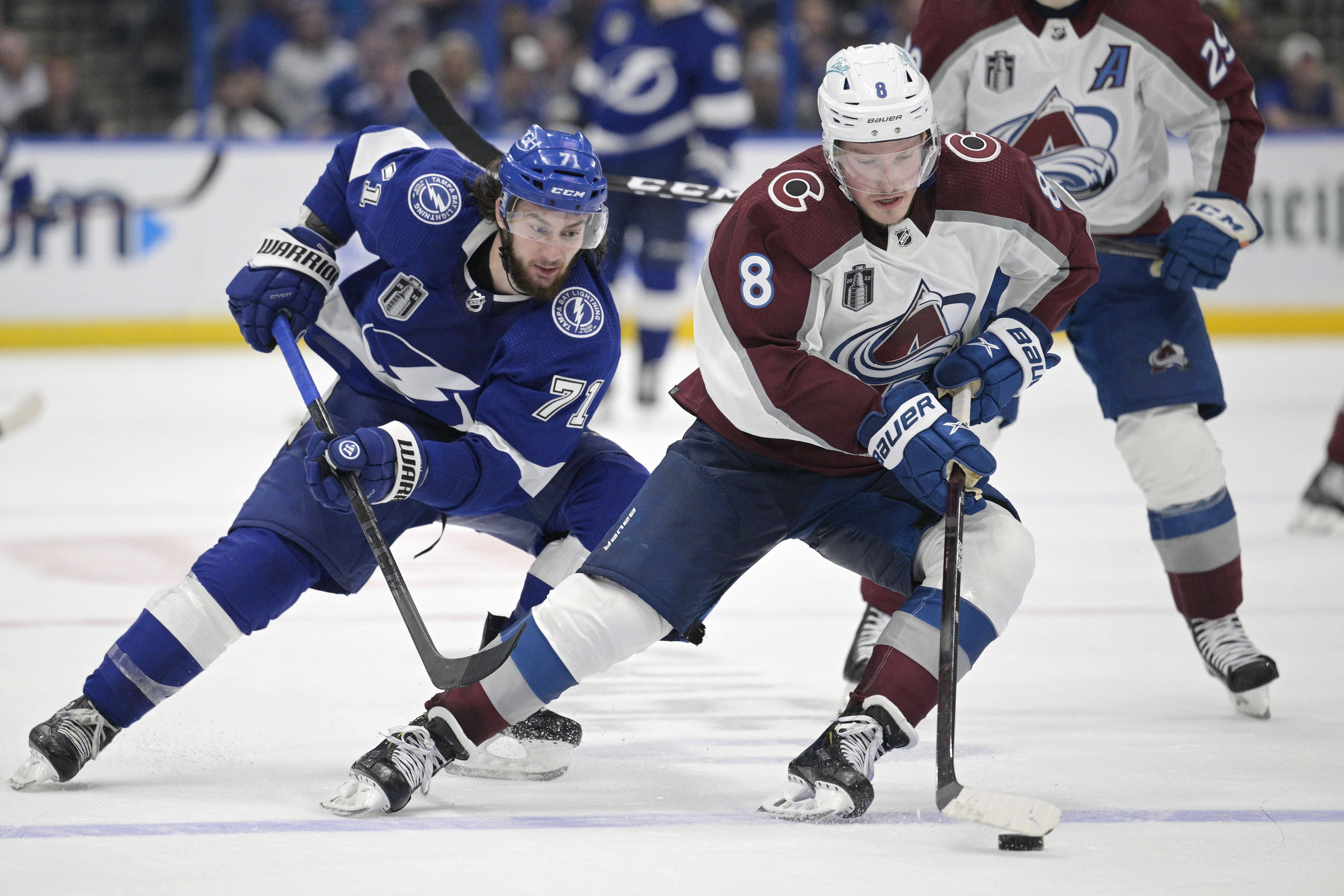 Colorado Avalanche defenseman Cale Makar (8) controls the puck next to Tampa Bay Lightning center Anthony Cirelli (71) during the third period of Game 4 of the NHL hockey Stanley Cup Finals on Wednesday, June 22, 2022, in Tampa, Fla. 