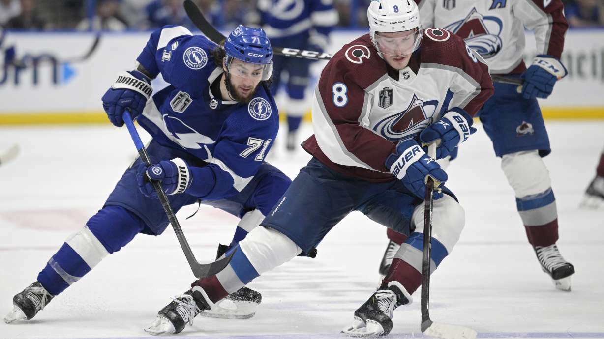 Colorado Avalanche defenseman Cale Makar (8) controls the puck next to Tampa Bay Lightning center Anthony Cirelli (71) during the third period of Game 4 of the NHL hockey Stanley Cup Finals on Wednesday, June 22, 2022, in Tampa, Fla.