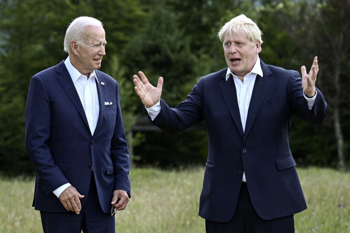 US President Joe Biden and Britain's Prime Minister Boris Johnson, right, chat as they gather for a group photo at Castle Elmau in Kruen, near Garmisch-Partenkirchen, Germany, on Sunday.