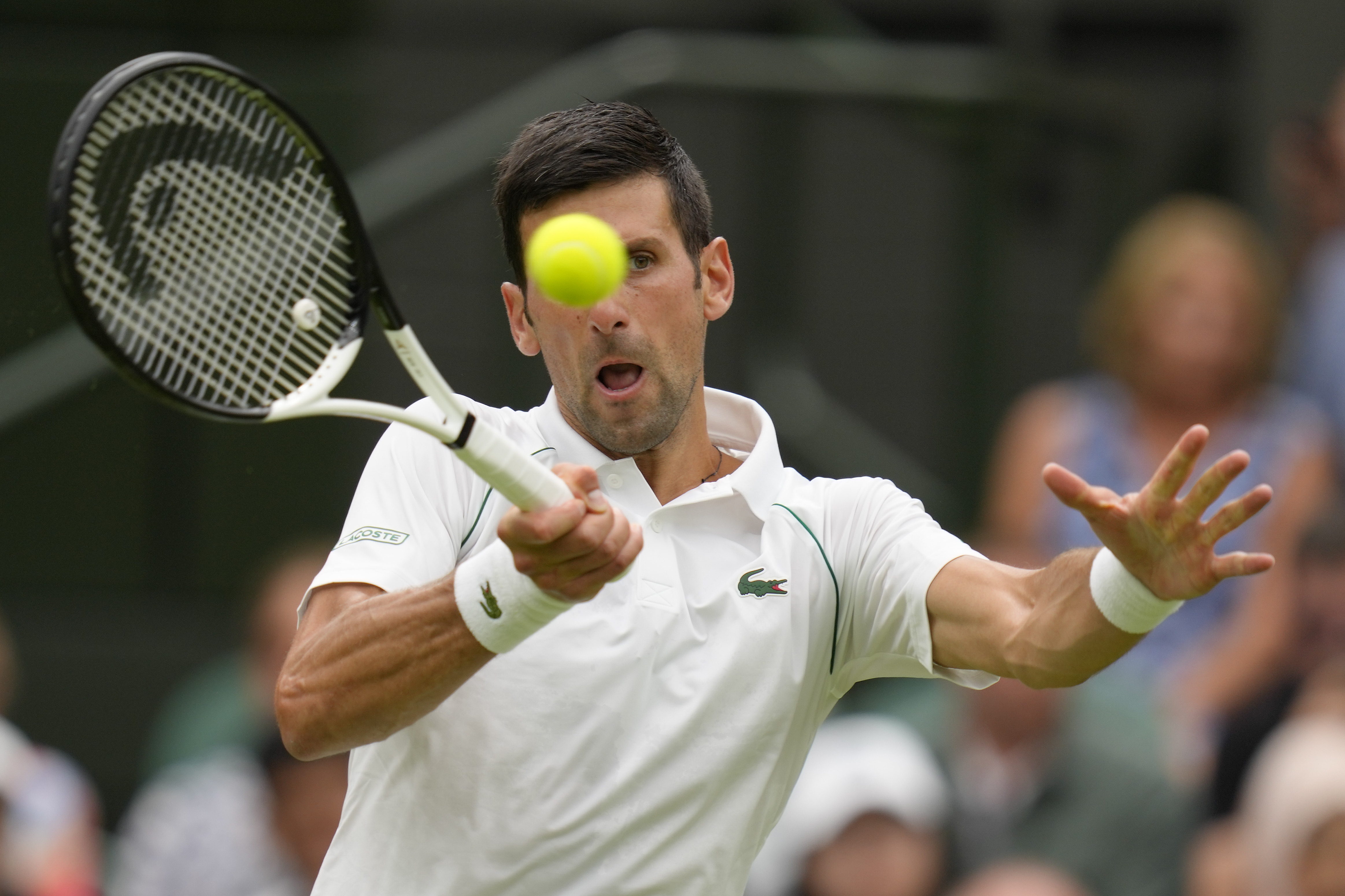 Serbia's Novak Djokovic returns to Korea's Kwon Soonwoo in a men's first round singles match on day one of the Wimbledon tennis championships in London, Monday, June 27, 2022. 