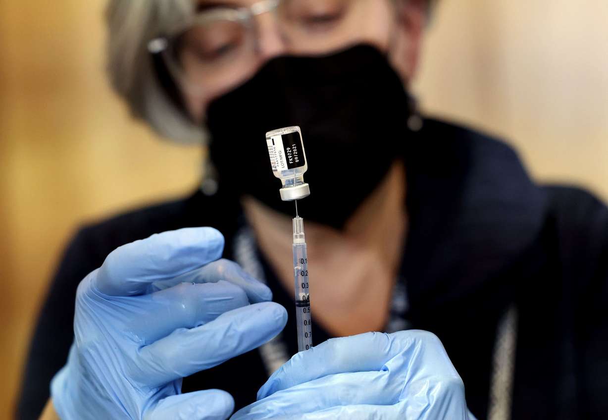 Community Nursing Services nurse Janie Wilson prepares a syringe of the Pfizer-BioNTech COVID-19 vaccine at the Olpin Student Union at the University of Utah in Salt Lake City on Thursday, Jan. 20, 2022.