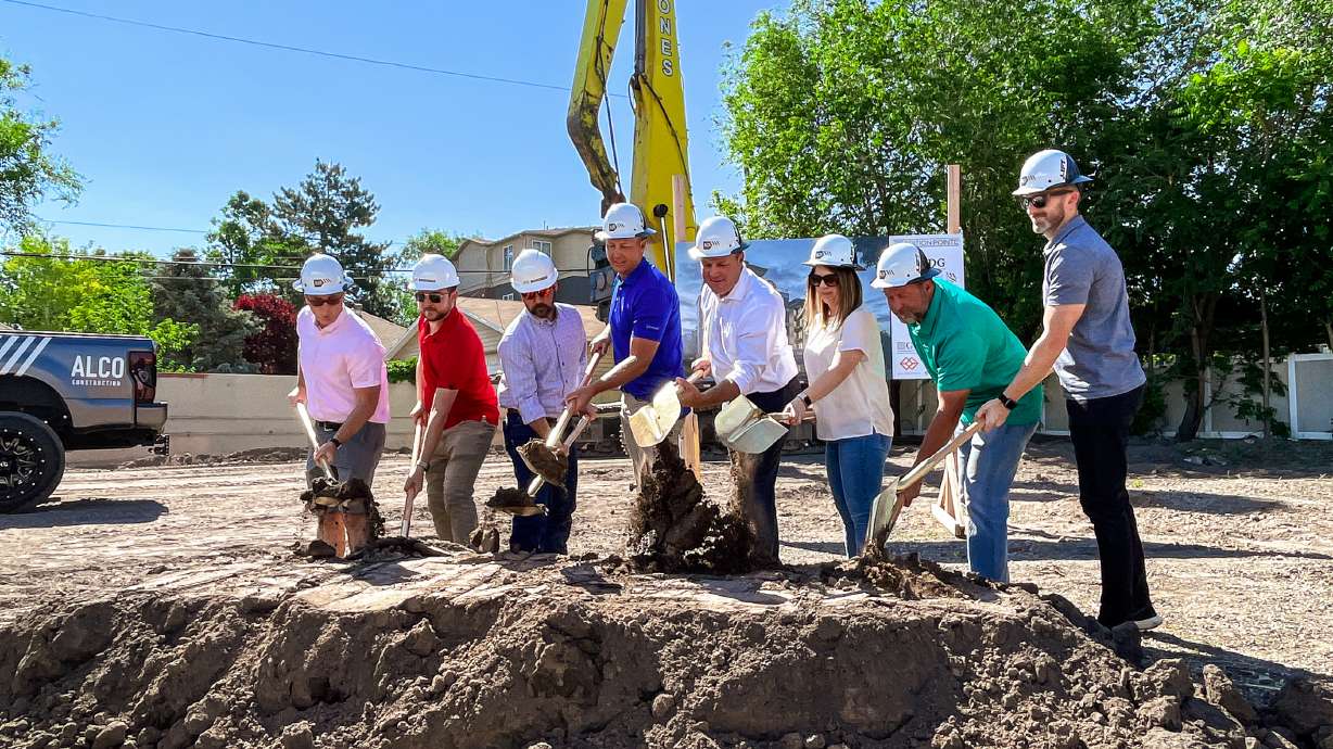 Rich Day, owner of Rich Day Group, fourth from left, and other leaders of the Tradition Pointe Luxury Apartments project break ground on the planned 77-unit apartment complex during a ceremony Monday.