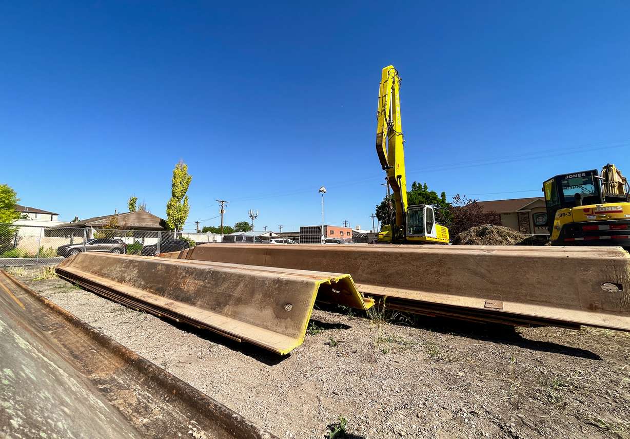 Construction vehicles and materials rest Monday morning in the lot that will soon become the Tradition Pointe Luxury Apartments.