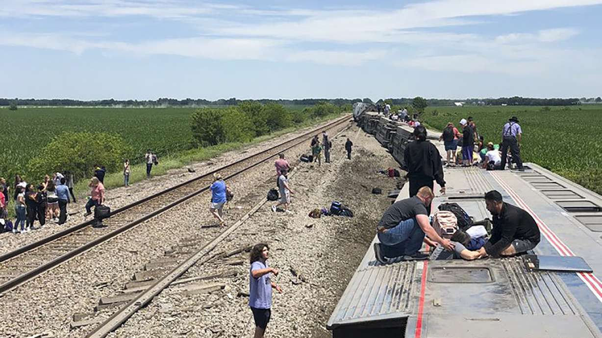 An Amtrak passenger train lies on its side after derailing near Mendon, Missouri, on Monday. The Southwest Chief, traveling from Los Angeles to Chicago, was carrying about 243 passengers when it collided with a dump truck near Mendon, Amtrak spokeswoman Kimberly Woods said.