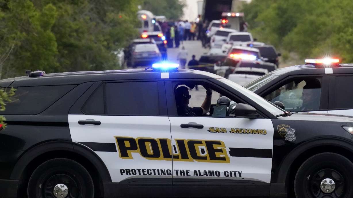 Police block the scene where a semitruck trailer with multiple dead bodies was discovered Monday in San Antonio.