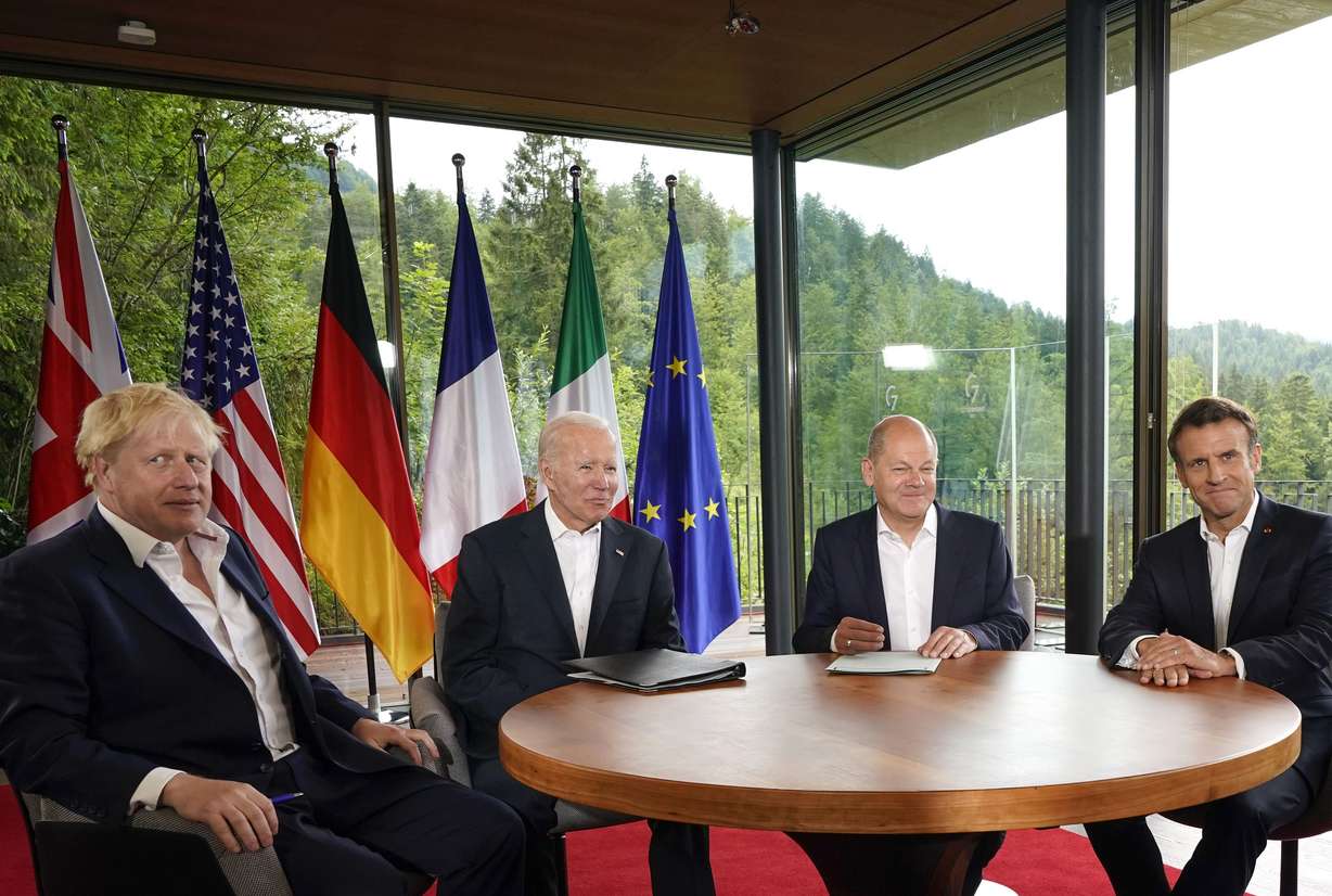 From left, British Prime Minister Boris Johnson, U.S. President Joe Biden, German Chancellor Olaf Scholz and French President Emmanuel Macron meet on the sidelines of the G7 summit at Castle Elmau in Kruen, near Garmisch-Partenkirchen, Germany, on Tuesday.