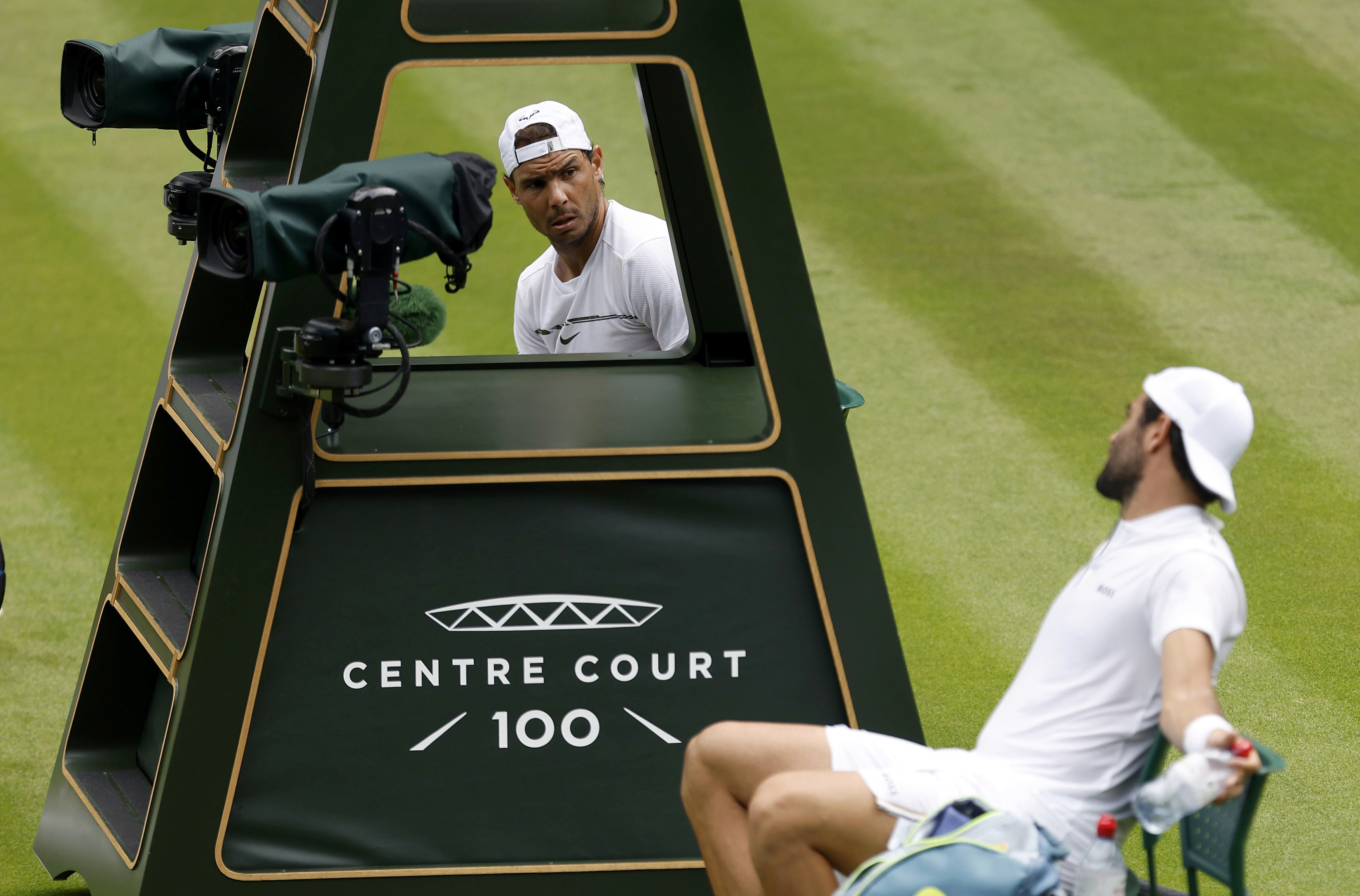 Italy's Matteo Berrettini, right, and Spain's Rafael Nadal talk to each other during their practice on Center Court ahead of the 2022 Wimbledon Championship at the All England Lawn Tennis and Croquet Club, in London, Thursday, June 23, 2022. 
