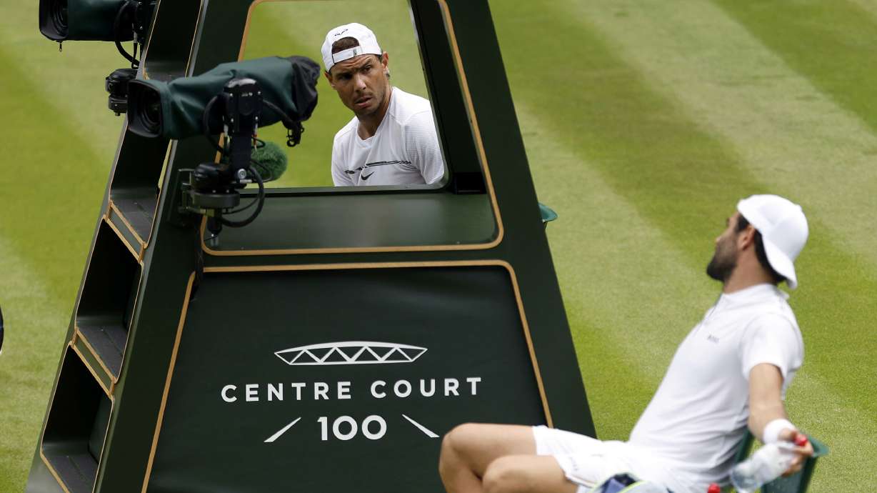 Italy's Matteo Berrettini, right, and Spain's Rafael Nadal talk to each other during their practice on Center Court ahead of the 2022 Wimbledon Championship at the All England Lawn Tennis and Croquet Club, in London, Thursday, June 23, 2022.