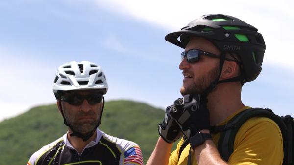 Mike Dbeisi and Austin Smith, mountain bikers and doctors at Intermountain Park City Hospital, demonstrate how a helmet should properly fit.