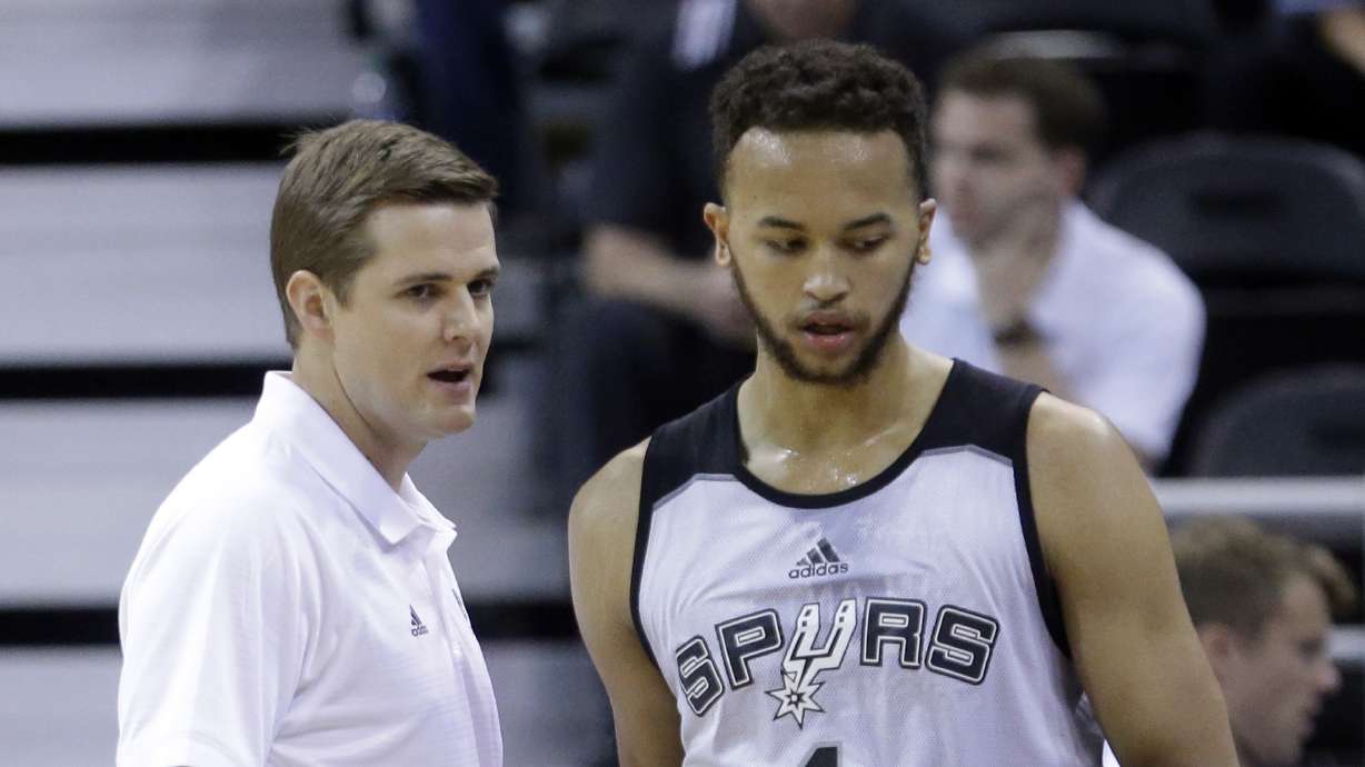 San Antonio Spurs summer league coach Will Hardy speaks with Spurs' Kyle Anderson during the first half of an NBA summer league basketball game against the Boston Celtics on Thursday, July 9, 2015, in Salt Lake City.