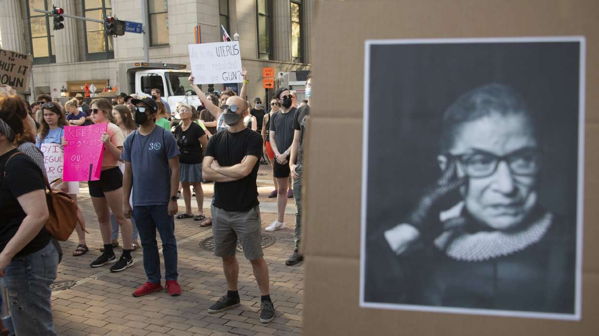 A sign depicting the late Supreme Court Justice Ruth Bader Ginsburg is held up at a pro-abortion protest after the Supreme Court decision overturning Roe V. Wade on Friday.