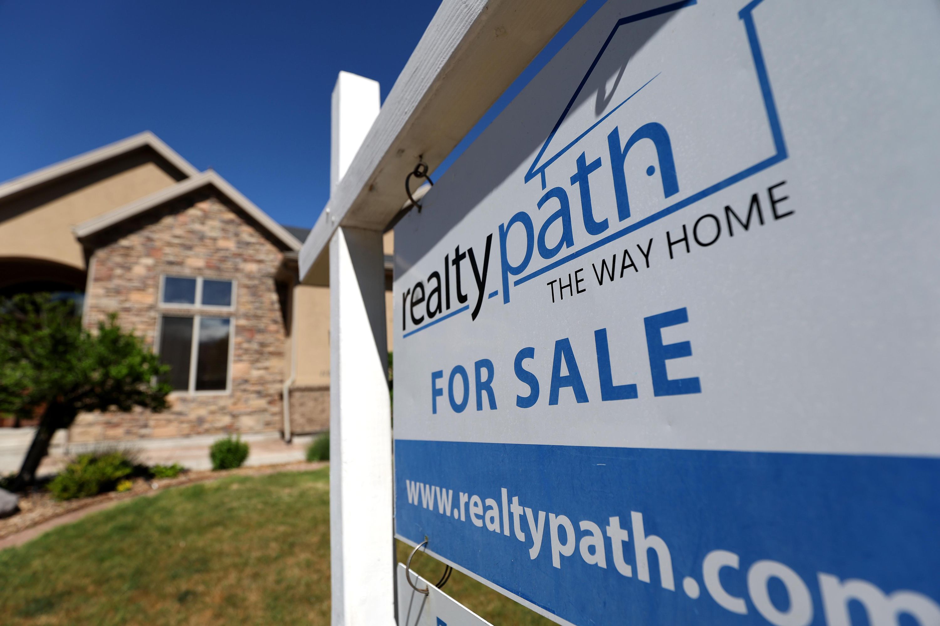 A “For Sale” sign is posted in the yard of a house in Sandy on May 31. Investors have played a significant part in fueling the red hot U.S. housing market and driving home prices up to record highs during the pandemic housing frenzy. 