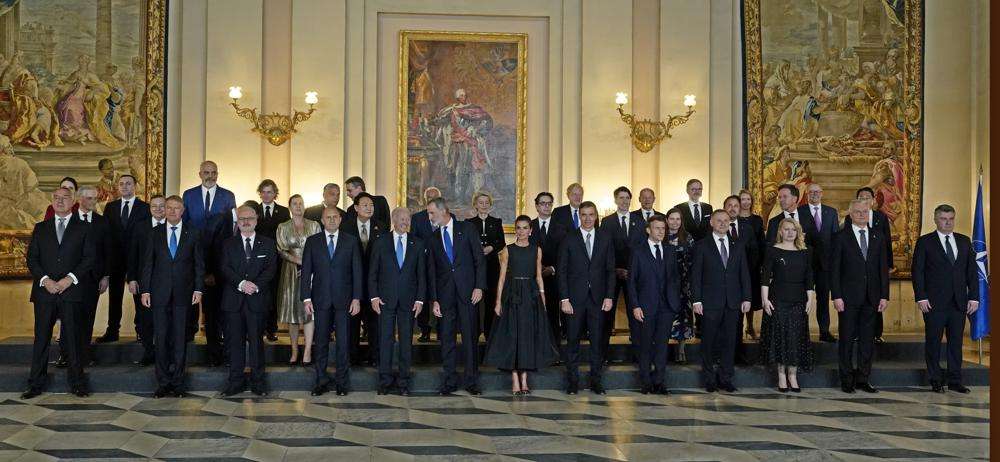 U.S. President Joe Biden, center left, speaks with Spain's King Felipe, center, during a group photo alongside other heads of state and dignitaries before a gala dinner at the Royal Palace in Madrid, Spain, Tuesday. North Atlantic Treaty Organization heads of state will meet for a NATO summit in Madrid from Tuesday through Thursday.