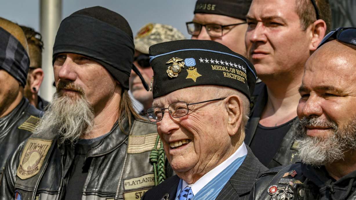 Hershel "Woody" Williams, center, poses with fellow Marines at the Charles E. Shelton Freedom Memorial at Smothers Park, April 6, 2019, in Owensboro, Ky. Williams, the last remaining Medal of Honor recipient from World War II, died Wednesday.
