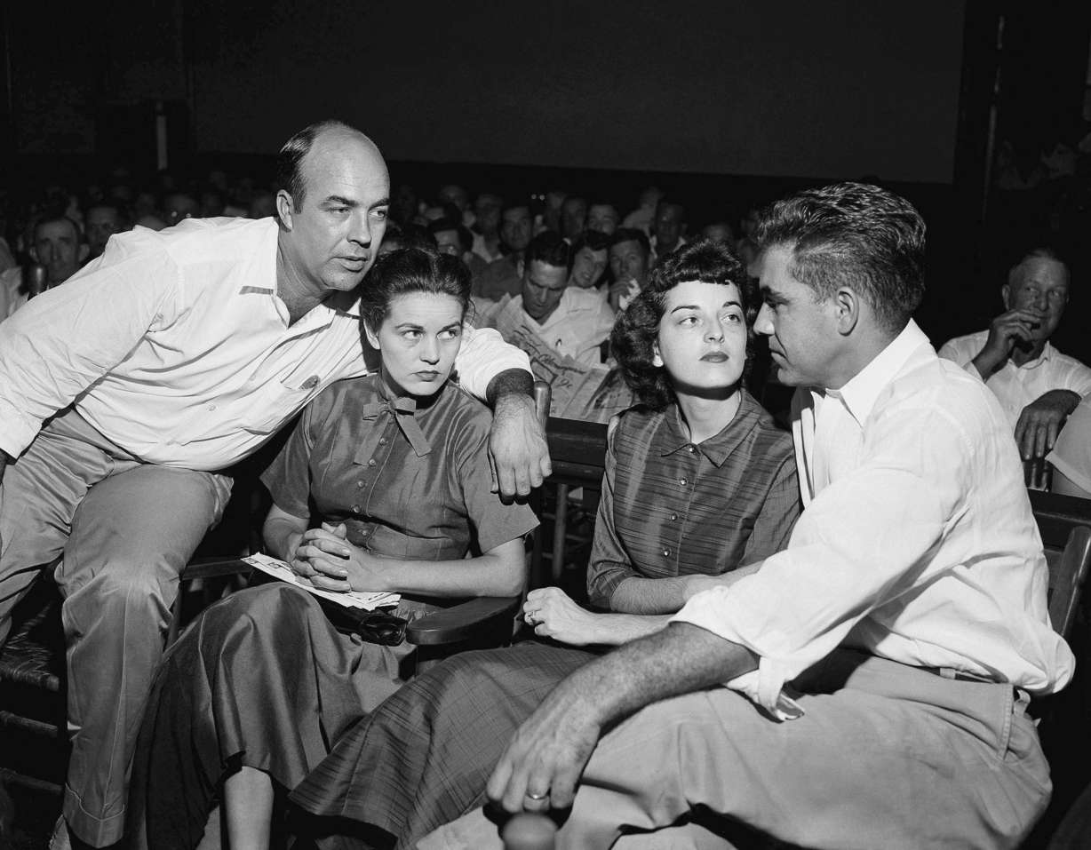 In this Sept. 23, 1955 photo, J.W. Milam, left, his wife, second from left, Roy Bryant, far right, and his wife, Carolyn Bryant, sit together in a courtroom in Sumner, Miss.