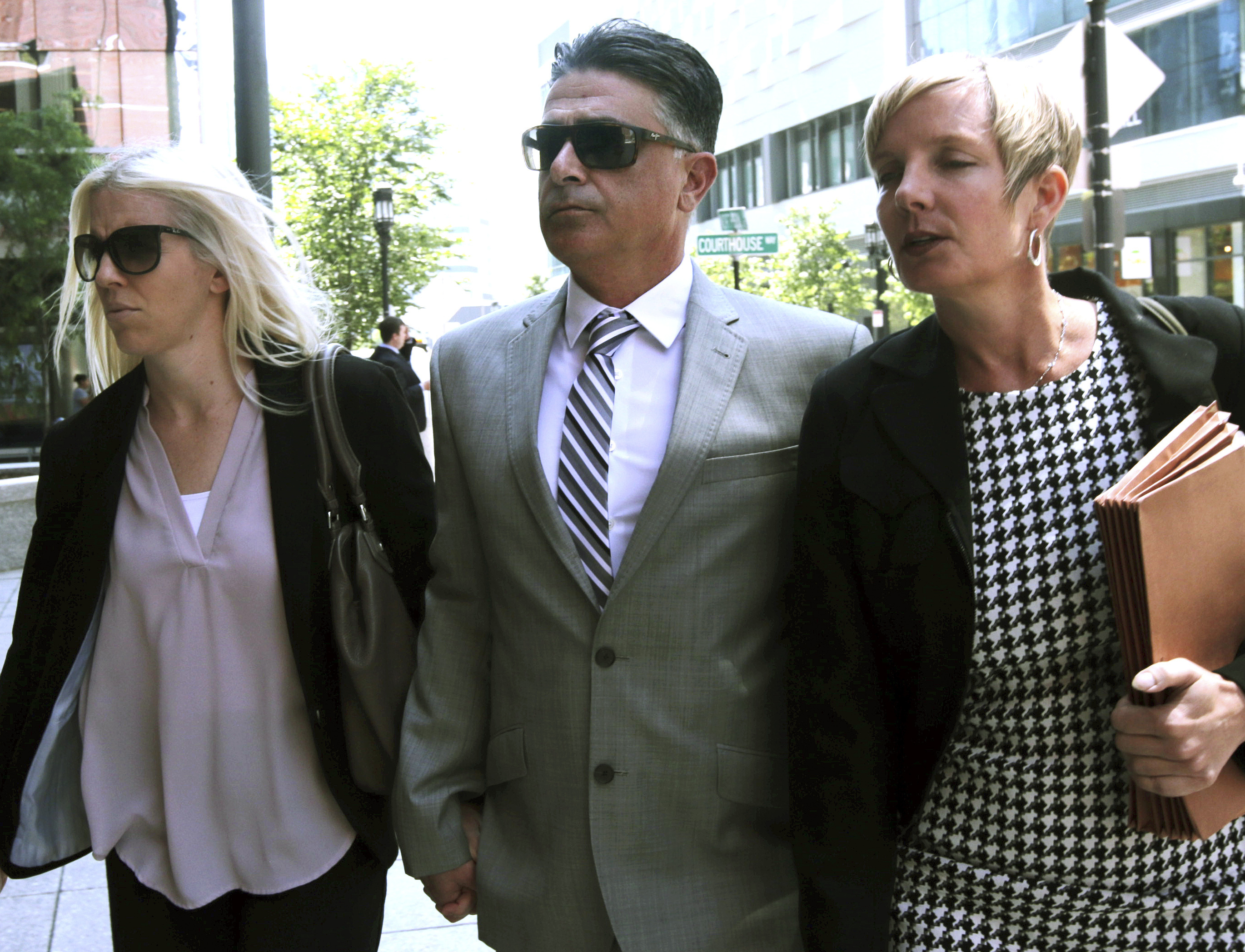 Former USC women's soccer coach Ali Khosroshahin, center, arrives at federal court, Thursday, June 27, 2019, to face charges in a nationwide college admissions bribery scandal, in Boston. Khosroshahin, who took bribes in exchange for helping unqualified kids get into USC, was sentenced Wednesday June 29, 2022, to six months in home confinement after cooperating with authorities investigating the sprawling college admissions scandal. 