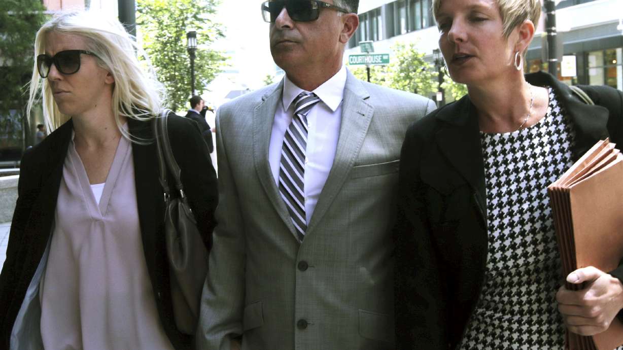Former USC women's soccer coach Ali Khosroshahin, center, arrives at federal court, Thursday, June 27, 2019, to face charges in a nationwide college admissions bribery scandal, in Boston. Khosroshahin, who took bribes in exchange for helping unqualified kids get into USC, was sentenced Wednesday June 29, 2022, to six months in home confinement after cooperating with authorities investigating the sprawling college admissions scandal.
