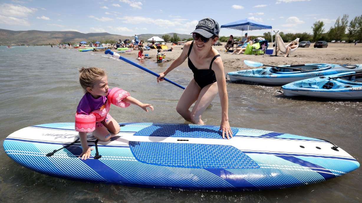 Christine Ray pushes daughter Bonnie Ray on a paddle board at Bear Lake’s Rendezvous Beach in Rich County on Wednesday. A new study reveals visitors to Bear Lake last summer pumped $48 million into the northern Utah region during more than a million days and nights of visitation.