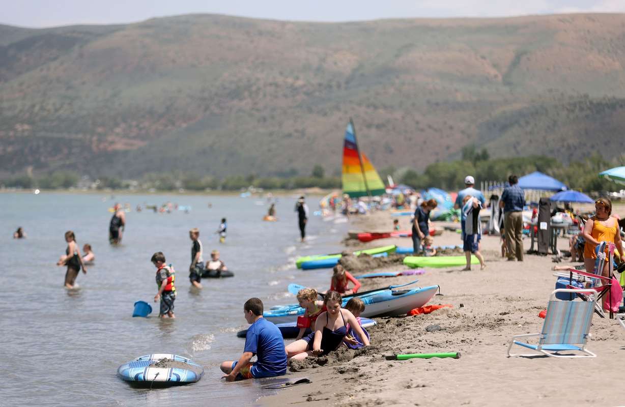People recreate at Rendezvous Beach on the south shore of Bear Lake in Rich County on Wednesday. A new study reveals visitors to Bear Lake last summer pumped $48 million into the northern Utah region during more than a million days and nights of visitation.