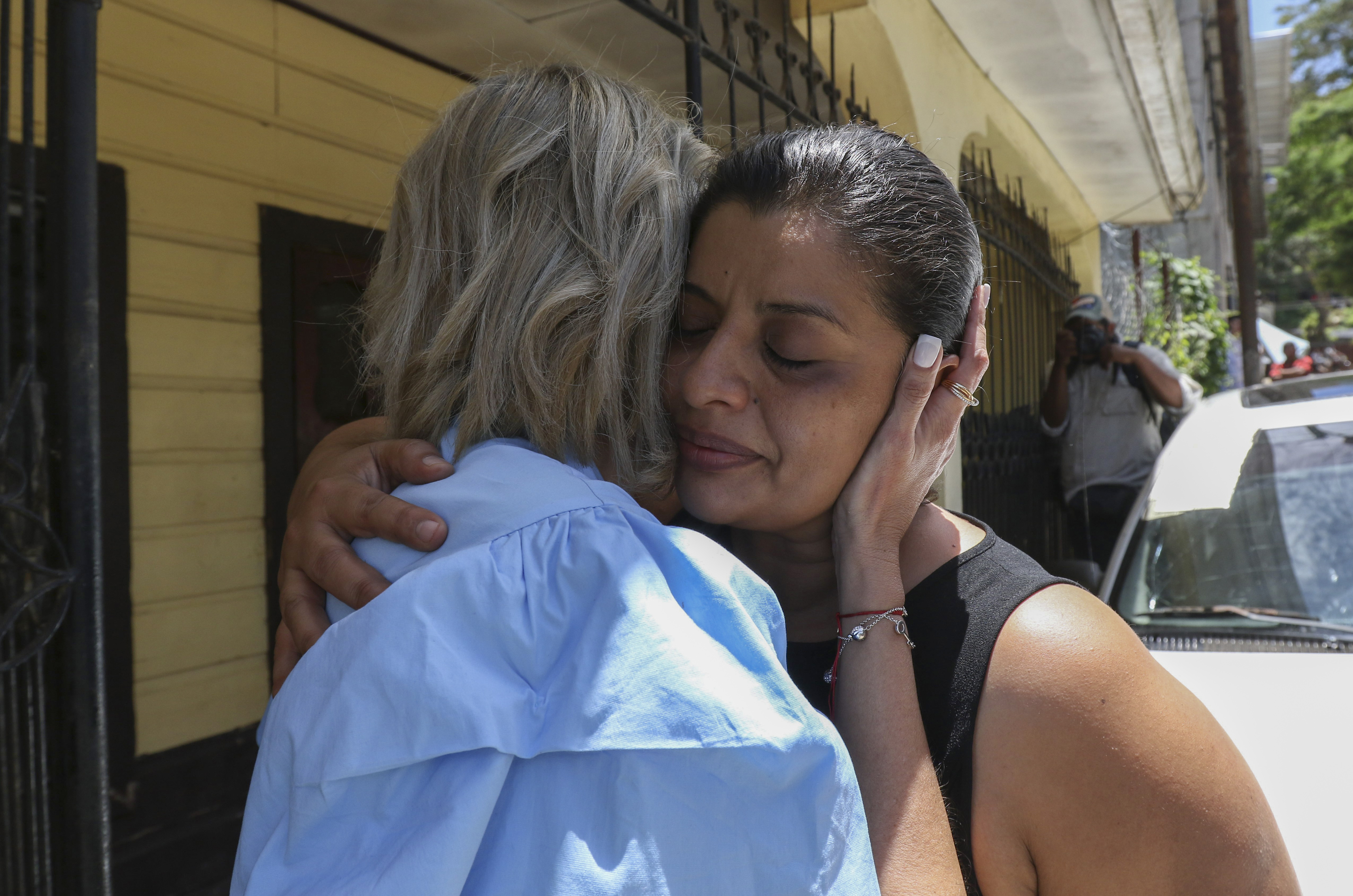 Karen Caballero, the mother of Fernando Redondo Caballero and Alejandro Andino Caballero who died near San Antonio, Texas, after being discovered in a hot trailer full of migrants being smuggled into the US, is comforted during an impromptu conference at their home in Las Vegas, Honduras, on Wednesday. Caballero's sons were among the bodies of 51 people discovered in what is believed to be the nation's deadliest smuggling episode on the U.S.-Mexico border.