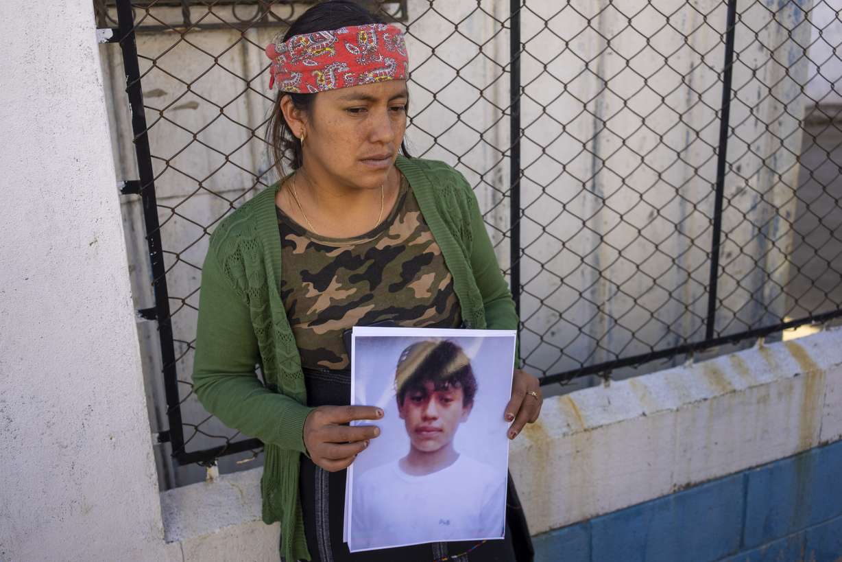 Maria Sipac Coj holds a portrait of her son Pascual Melvin Guachiac in Tzucubal, Guatemala, Wednesday. Pascual and his cousin Wilmer Tulul, both 13, were among the dead discovered inside a tractor-trailer near auto salvage yards on the edge of San Antonio, Texas, on Monday.