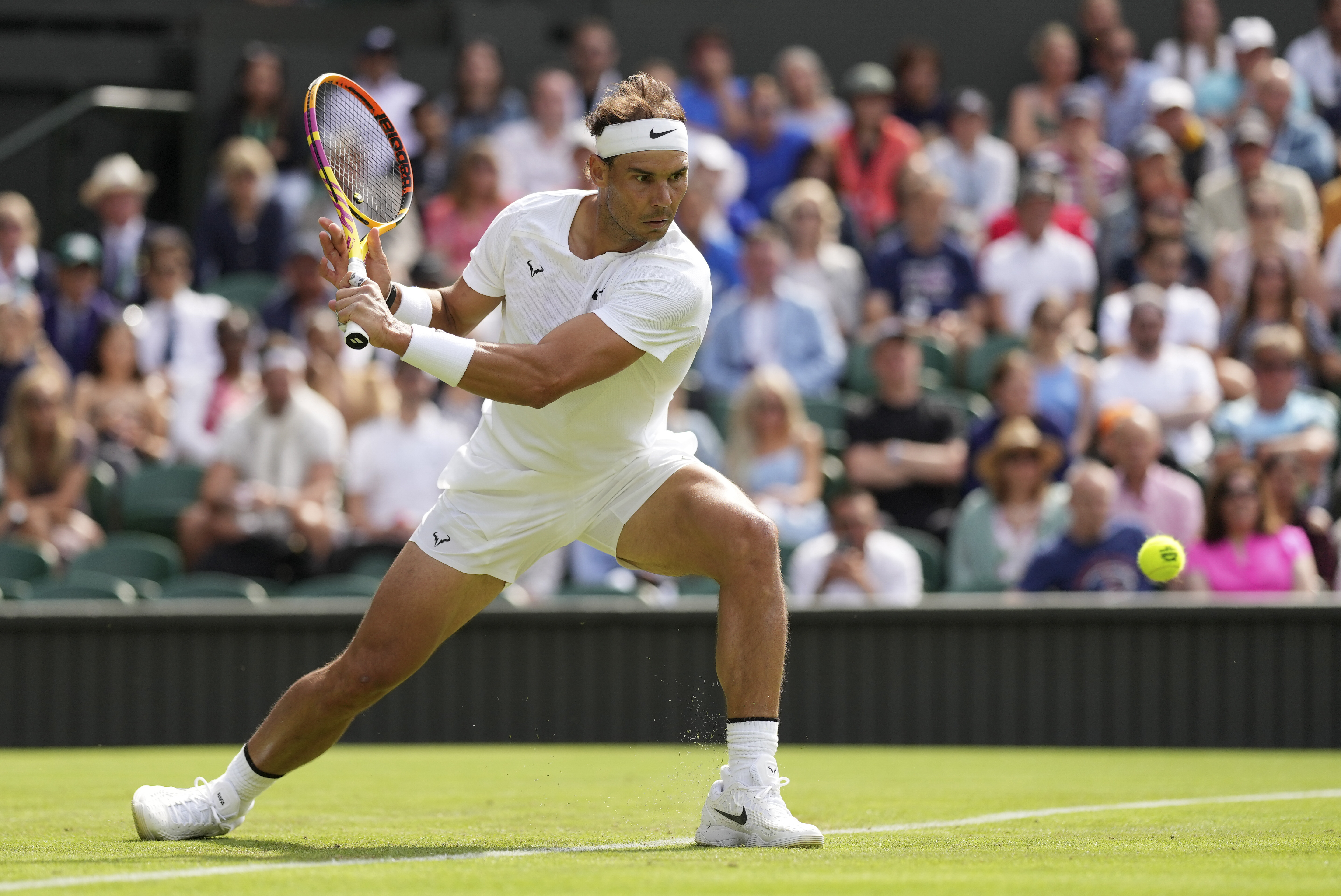 Spain's Rafael Nadal returns to Argentina's Francisco Cerundolo in a first round men's singles match on day two of the Wimbledon tennis championships in London, Tuesday, June 28, 2022. 