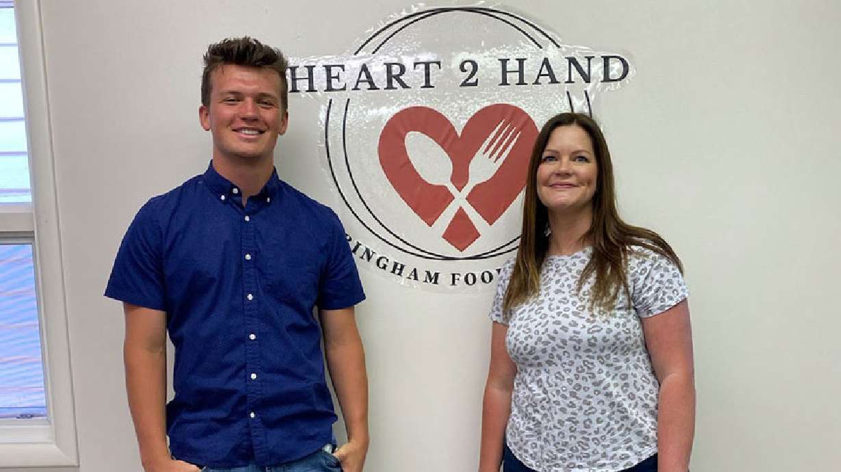 Ryker Clinger, a Shelley high school senior, raised over $100,000 for the Heart 2 Hand Bingham Food Pantry. He is pictured with Jenni Worlton, director of Heart 2 Hand.