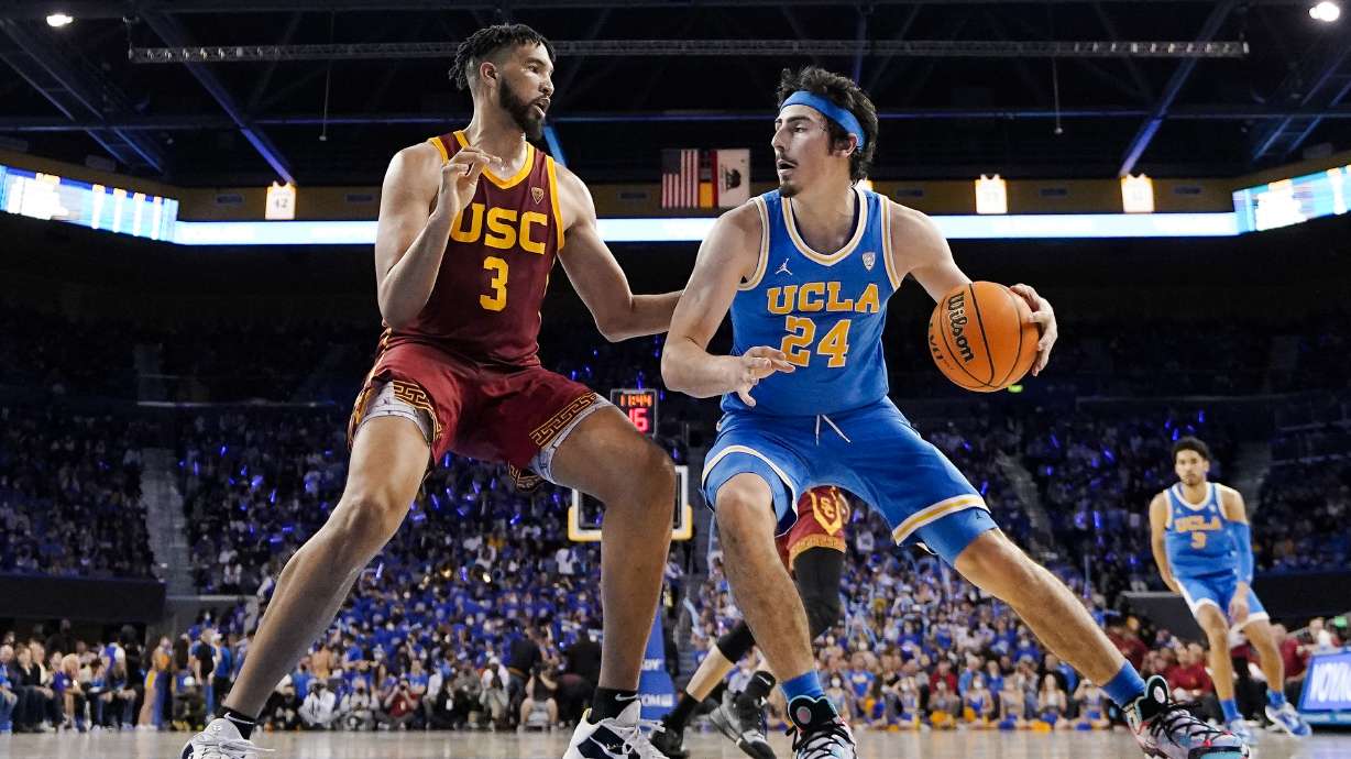 FILE - UCLA guard Jaime Jaquez Jr., right, tries to get by Southern California forward Isaiah Mobley during the second half of an NCAA college basketball game on March 5, 2022, in Los Angeles. UCLA and Southern California are planning to leave the Pac-12 for the Big Ten Conference in a seismic change that could lead to another major realignment of college sports. A person who spoke to The Associated Press on Thursday, June 30, 2022, on condition of anonymity because the schools' talks with the Big Ten have not been made public said the schools have taken steps to request an invitation to join the conference.