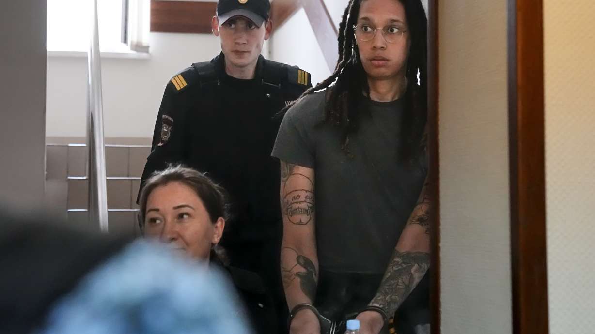 FILE - WNBA star and two-time Olympic gold medalist Brittney Griner is escorted to a courtroom for a hearing, in Khimki just outside Moscow, Russia, Monday, June 27, 2022. U.S. basketball star Brittney Griner is set to go on trial in a Moscow-area court Friday July 1. The proceedings that are scheduled to begin Friday come about 4 1/2 months after she was arrested on cannabis possession charges at an airport while traveling to play for a Russian team.