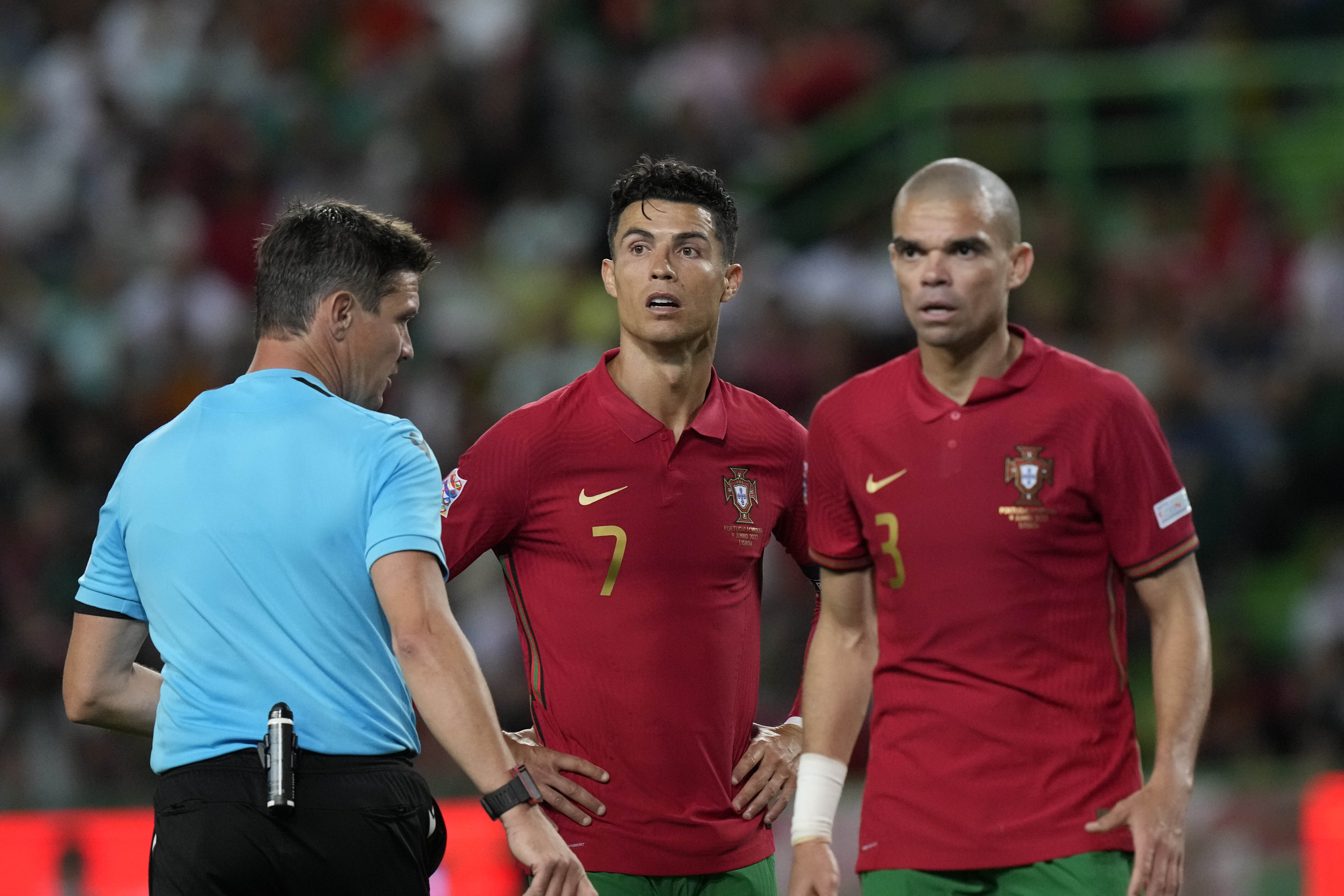 Portugal's Cristiano Ronaldo and his teammate Pepe look to the referee Matej Jug during the UEFA Nations League soccer match between Portugal and the Czech Republic, at the Jose Alvalade Stadium in Lisbon, Thursday, June 9, 2022. 