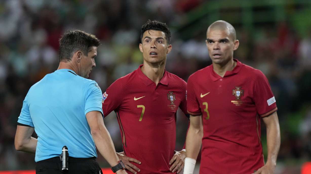 Portugal's Cristiano Ronaldo and his teammate Pepe look to the referee Matej Jug during the UEFA Nations League soccer match between Portugal and the Czech Republic, at the Jose Alvalade Stadium in Lisbon, Thursday, June 9, 2022.