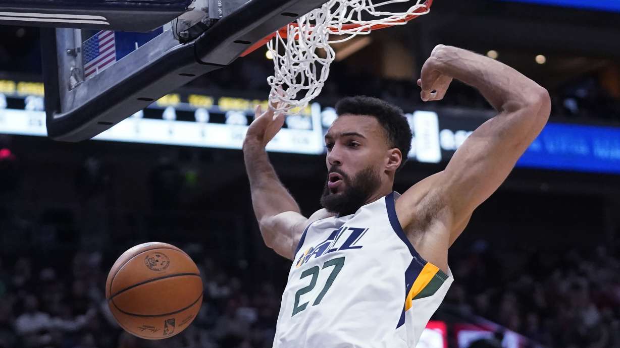 FILE - Utah Jazz center Rudy Gobert dunks against the Houston Rockets during the second half of an NBA basketball game on Feb. 14, 2022, in Salt Lake City. Gobert has been traded by the Jazz to the Minnesota Timberwolves for a massive package of players and draft picks, a person with knowledge of the blockbuster deal said. Utah is getting four first-round picks between 2023 and 2029, along with Patrick Beverley, Malik Beasley and a first-round pick this year in Walker Kessler, according to the person who spoke to The Associated Press on Friday, July 1, 2022, on condition of anonymity because the NBA had not approved the deal and neither team could announce it publicly.