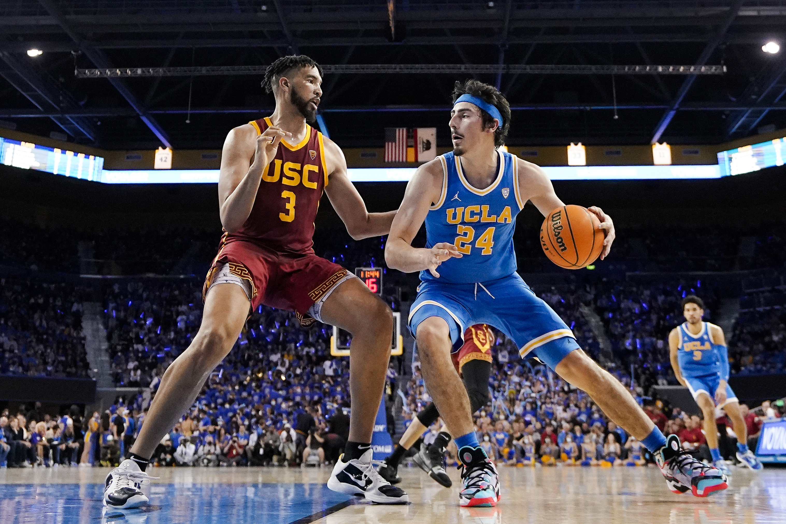 FILE - UCLA guard Jaime Jaquez Jr., right, tries to get by Southern California forward Isaiah Mobley during the second half of an NCAA college basketball game on March 5, 2022, in Los Angeles. UCLA and Southern California are planning to leave the Pac-12 for the Big Ten Conference in a seismic change that could lead to another major realignment of college sports. A person who spoke to The Associated Press on Thursday, June 30, 2022, on condition of anonymity because the schools' talks with the Big Ten have not been made public said the schools have taken steps to request an invitation to join the conference. 