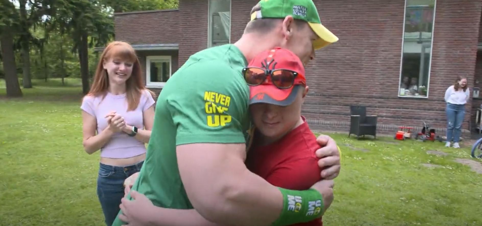 John Cena, left, hugs Misha, a Ukrainian teen with Down syndrome.