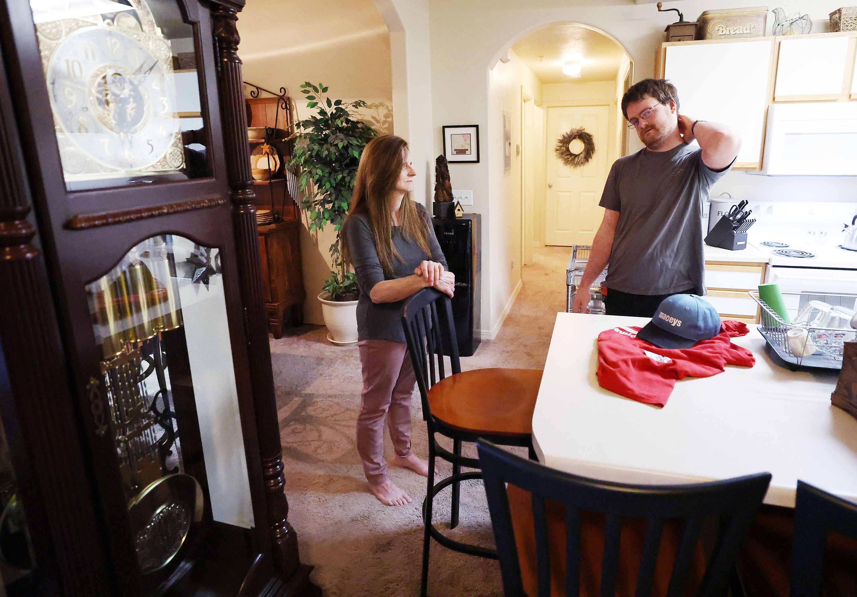 Andrew Asay talks with his mother, Debbie Koontz, at their apartment in Pleasant Grove on June 21. Asay shares the apartment with his mother and sister and they are buying a house together.