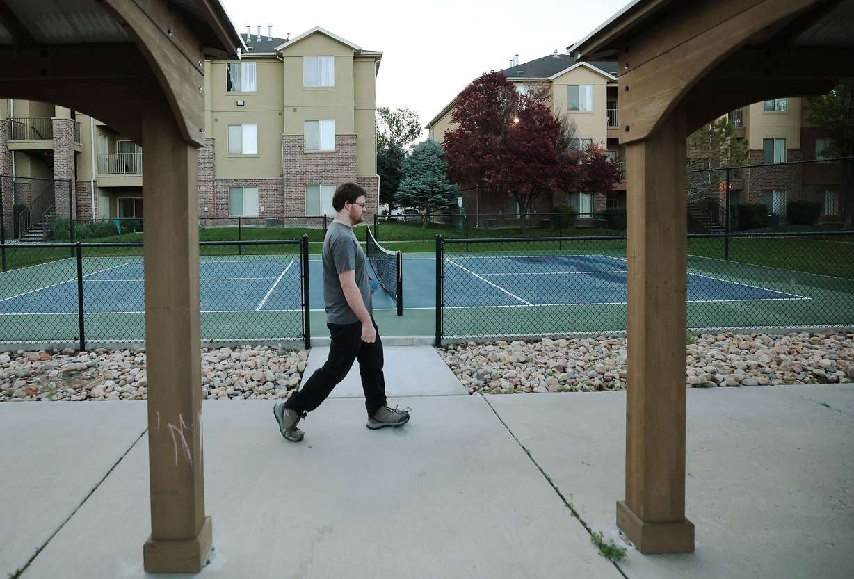 Andrew Asay walks to his car from his apartment in Pleasant Grove on June 21. Asay shares the apartment with his mother and sister and they are buying a house together.