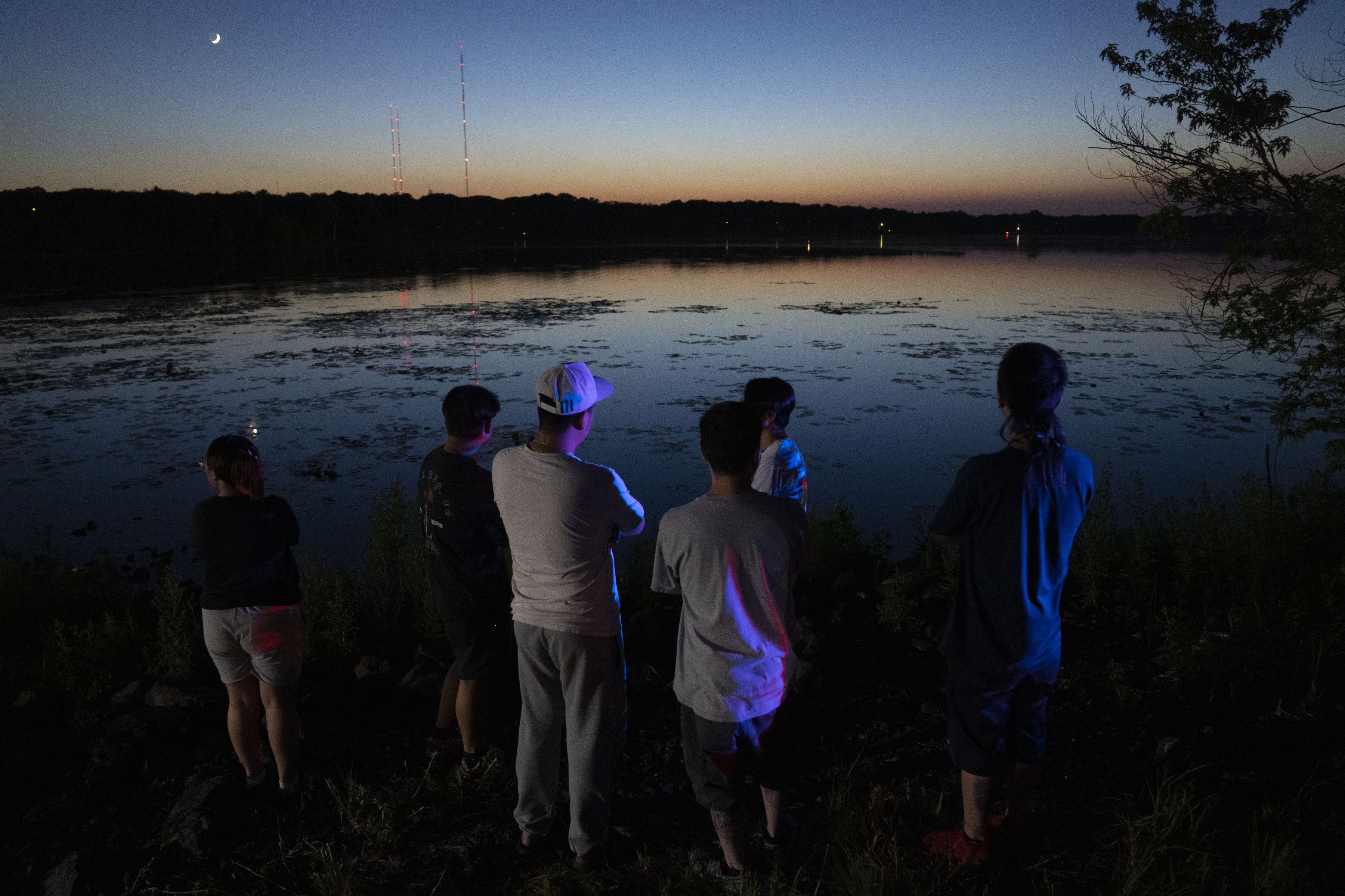 Friends and family gathered at Vadnais Lake after news of a dead child being pulled out of the lake broke, Friday in Vadnais Heights, Minn. The bodies of two young children have been recovered from the Minnesota lake, and searchers are still looking for a third they fear may have been intentionally drowned.