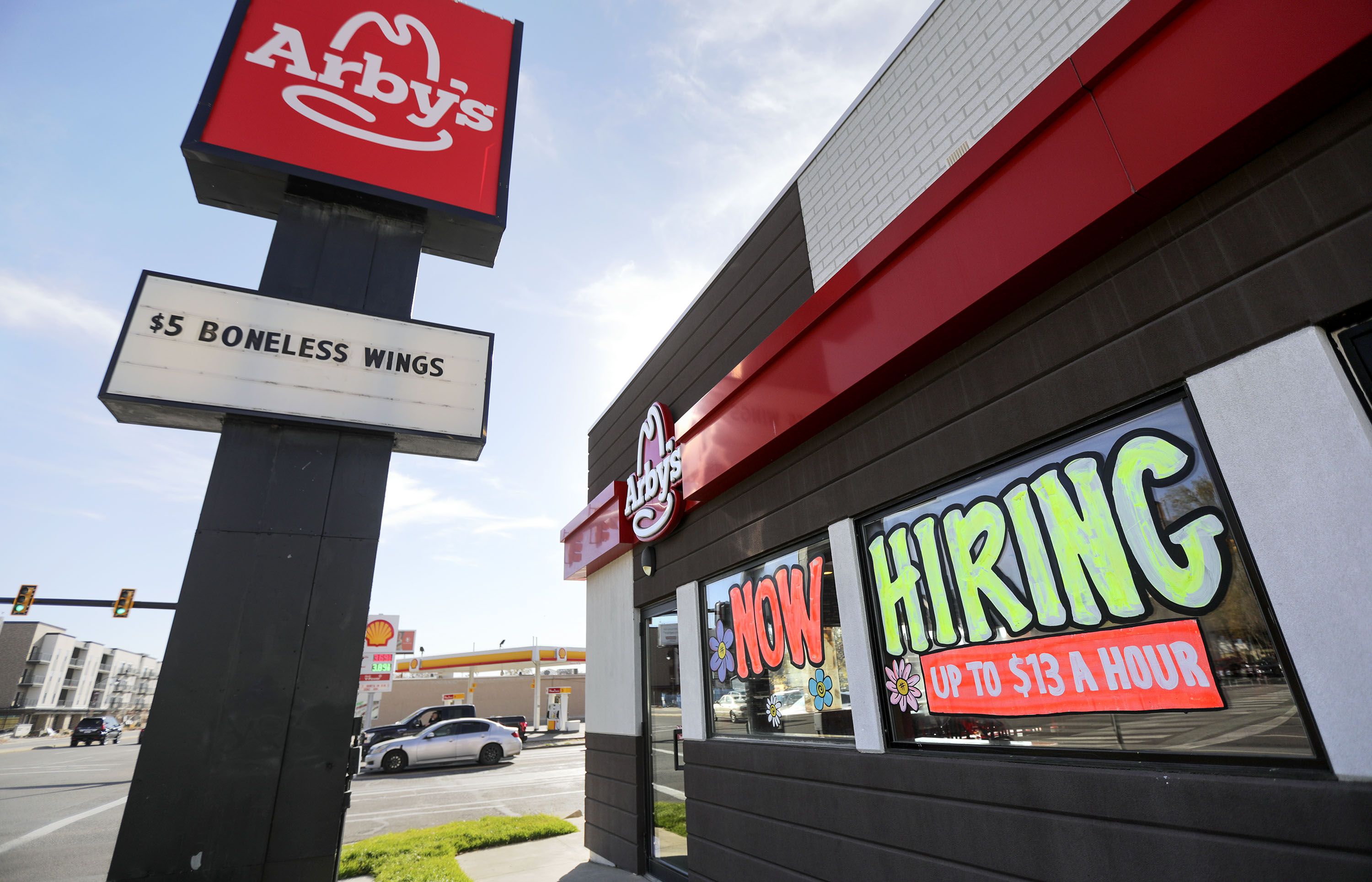 A “now hiring” sign is pictured at an Arby’s in Salt Lake City on Nov. 5, 2021. As record high U.S. inflation continues to have the most severe impacts on lower income individuals and families, new hourly minimum wage standards went into effect on Friday in 20 states, cities and counties across the country.
