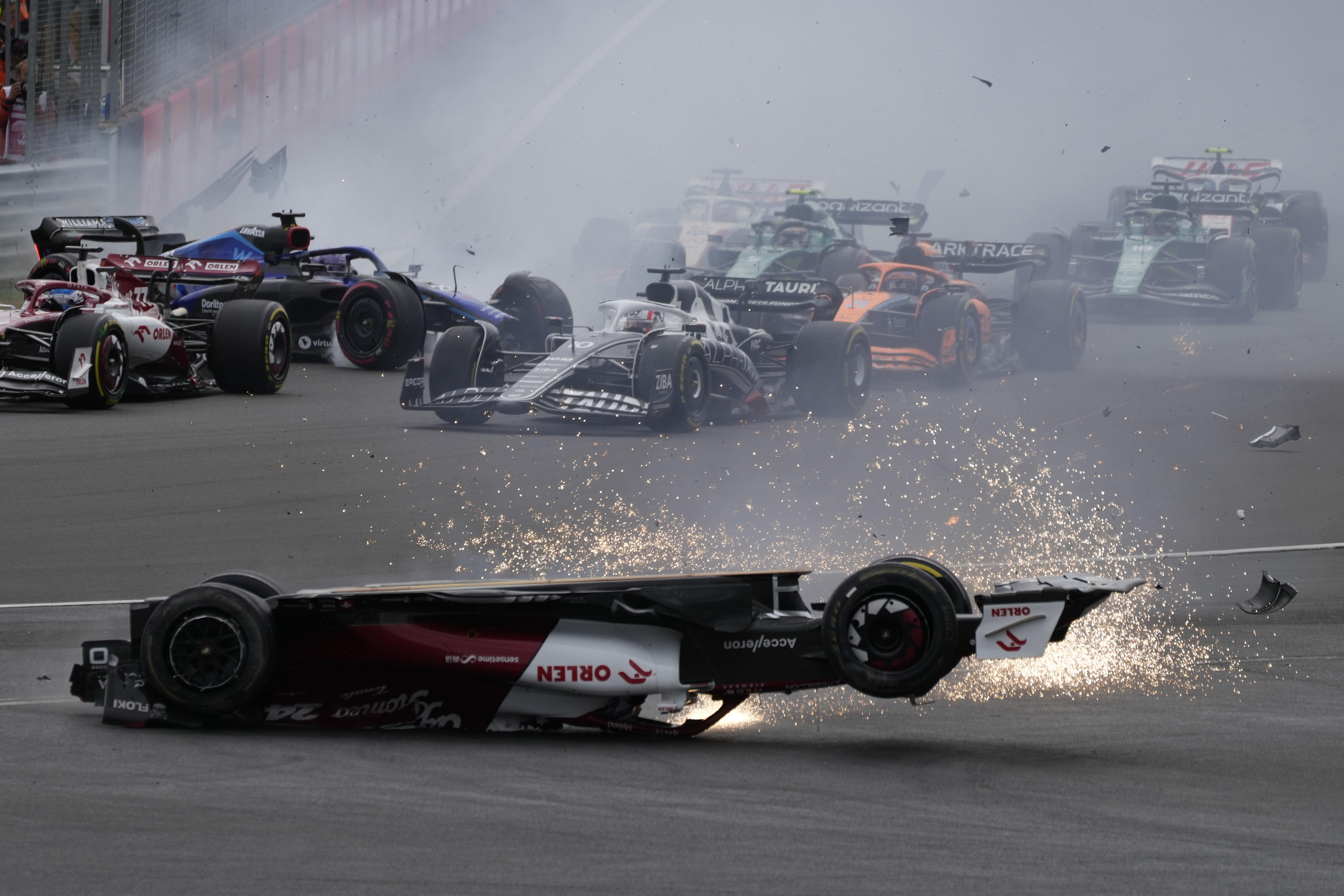 Alfa Romeo driver Guanyu Zhou of China crashes at the start of the British Formula One Grand Prix at the Silverstone circuit, in Silverstone, England, Sunday, July 3, 2022. 