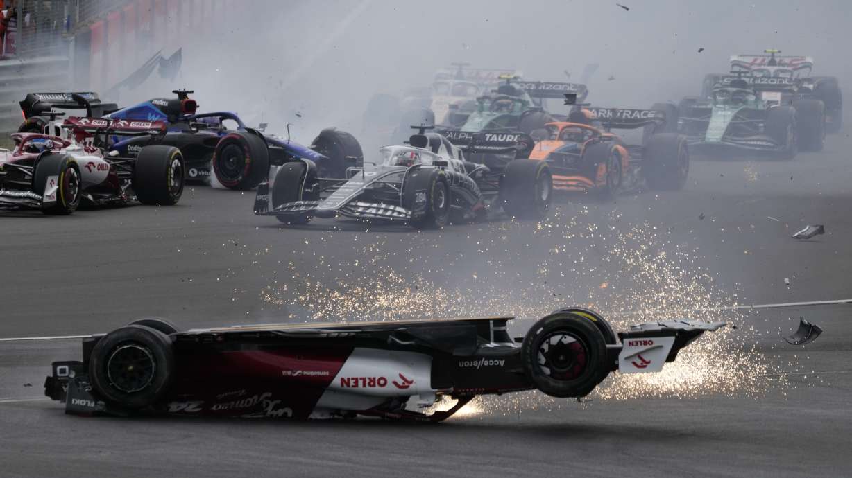 Alfa Romeo driver Guanyu Zhou of China crashes at the start of the British Formula One Grand Prix at the Silverstone circuit, in Silverstone, England, Sunday, July 3, 2022.