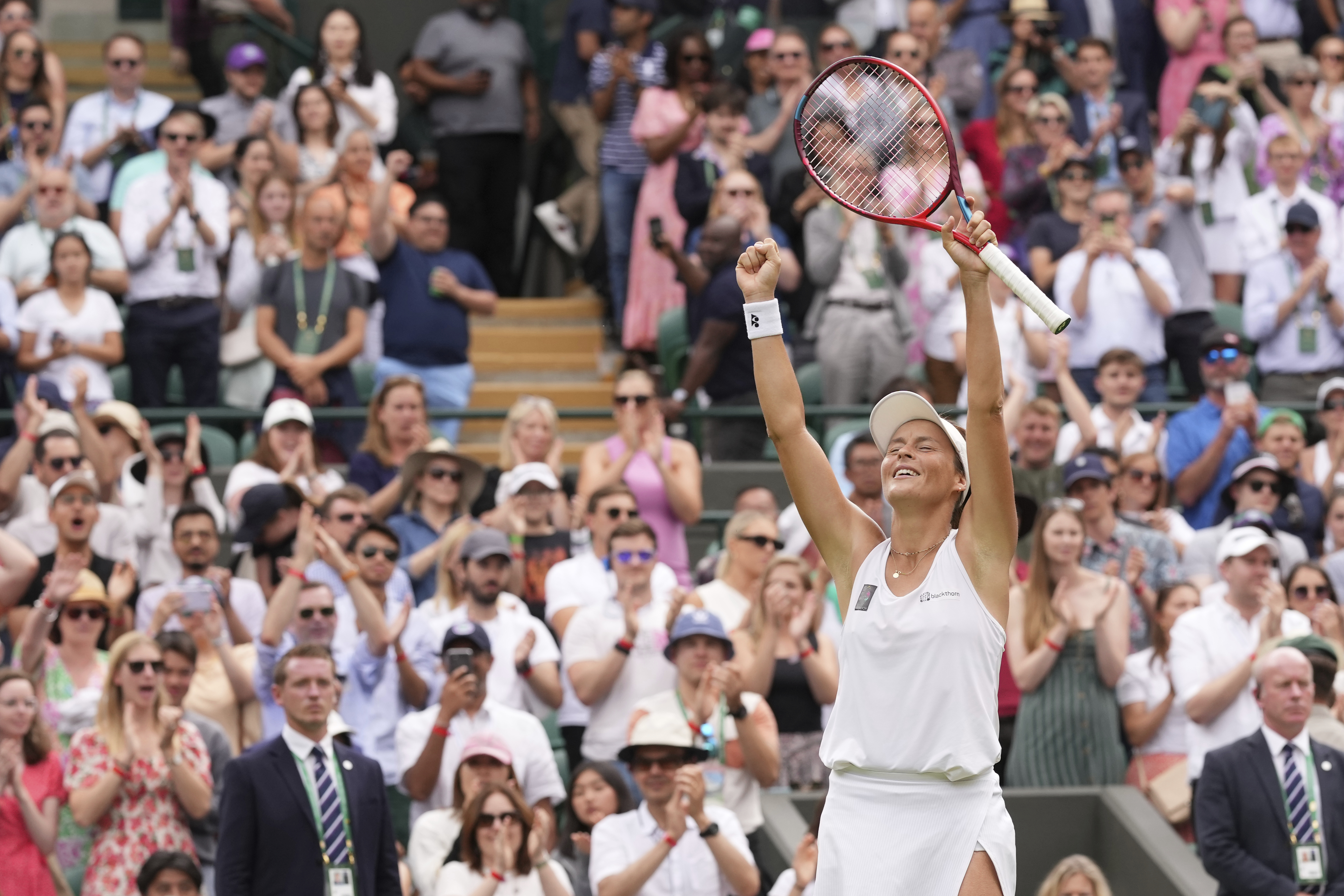 Germany's Tatjana Maria celebrates defeating Latvia's Jelena Ostapenko during a fourth round women's singles match on day seven of the Wimbledon tennis championships in London, Sunday, July 3, 2022. 