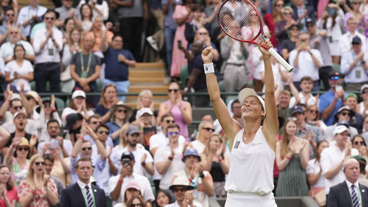 Germany's Tatjana Maria celebrates defeating Latvia's Jelena Ostapenko during a fourth round women's singles match on day seven of the Wimbledon tennis championships in London, Sunday, July 3, 2022.