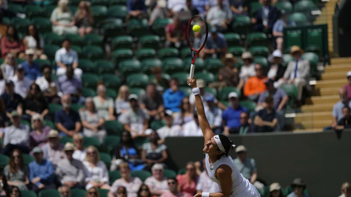 France's Caroline Garcia serves to Marie Bouzkova of the Czech Republic in a fourth round women's singles match on day seven of the Wimbledon tennis championships in London, Sunday July 3, 2022.