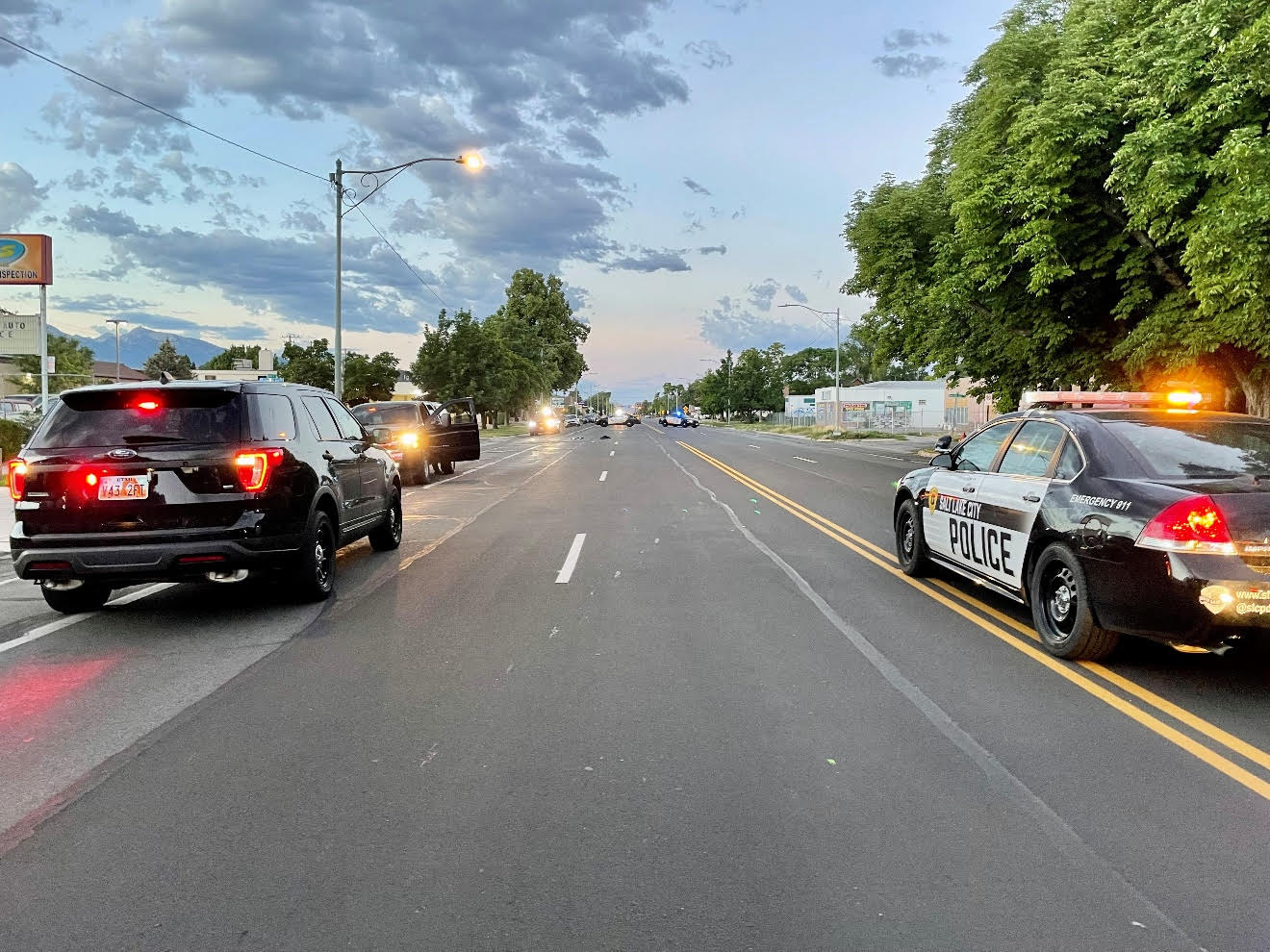 Salt Lake police squad cars parked near the scene to a shooting at 1485 S. Major Street on Sunday. The shooting left a man severely injured; two men were arrested in connection with the incident on Monday.