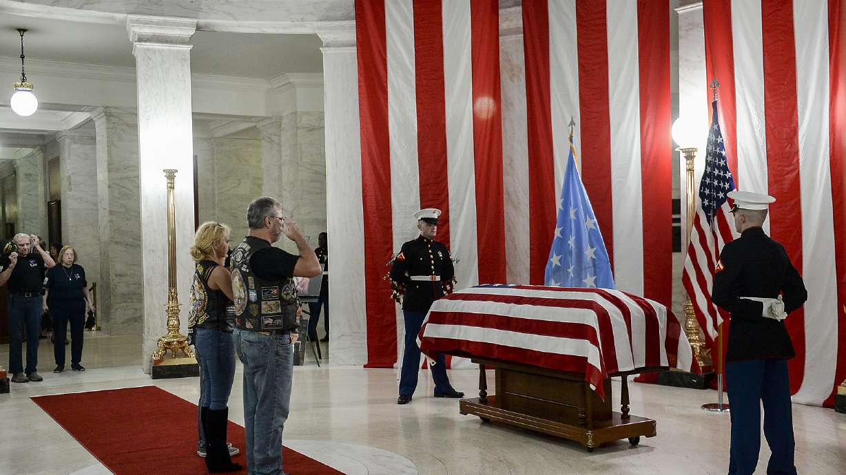 People salute the casket of Hershel "Woody" Williams set up in the first floor rotunda of the West Virginia State Capitol in Charleston, W.Va., for visitation on Saturday. Williams, 98, a West Virginian who was the last living Medal of Honor recipient from World War II, died on Wednesday, June 29. His funeral is set for Sunday.