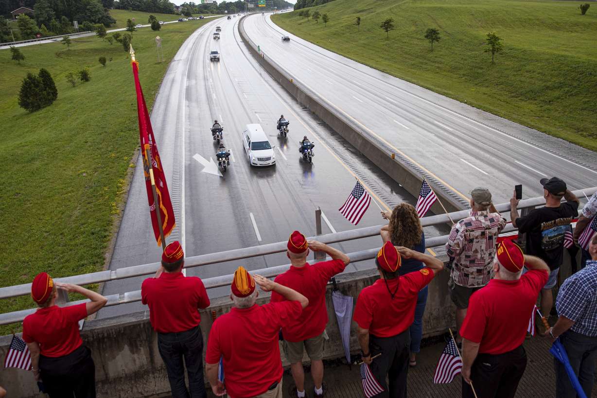Marine Corps League veterans salute as the funeral procession for Medal of Honor recipient Hershel "Woody" Williams moves along Interstate 64 on Saturday, in Teays Valley, W.Va.