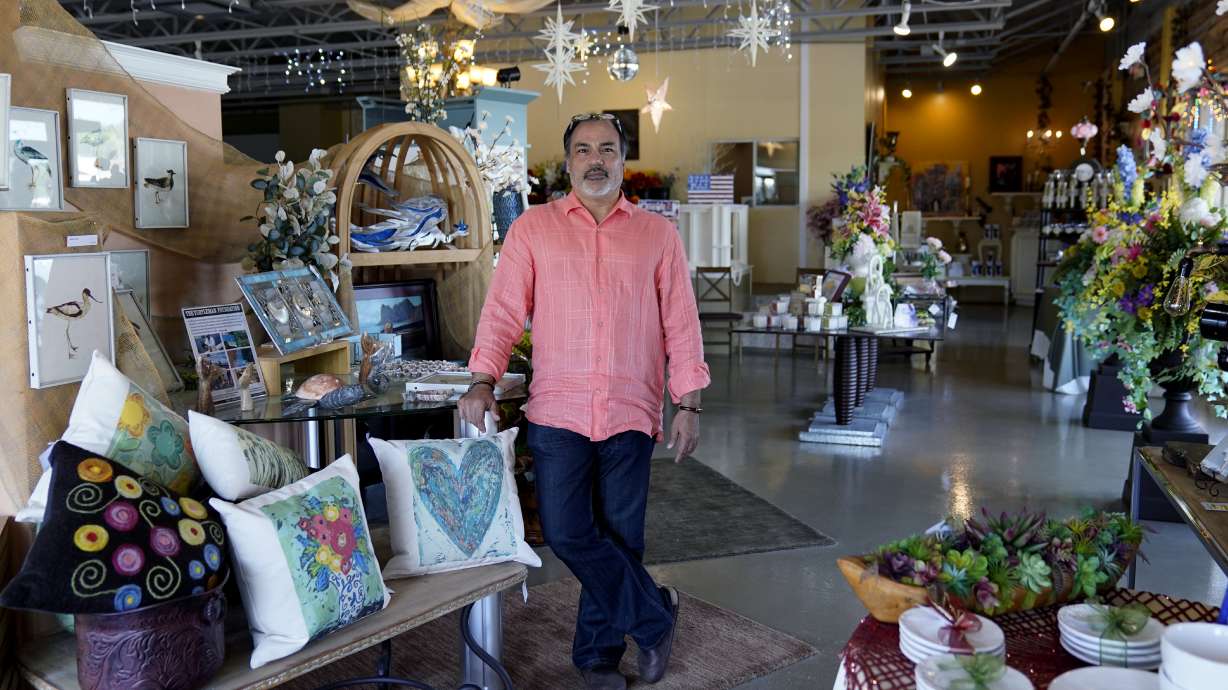 Martin Garcia, owner of gift and décor store Gramercy Gift Gallery, poses for a photo at his shop, Wednesday, in San Antonio. Landlords were forgiving about rent during the first two years of the pandemic, but now many are asking for back due rent. Meanwhile, most of the government aid programs that helped small businesses get through the pandemic have ended.
