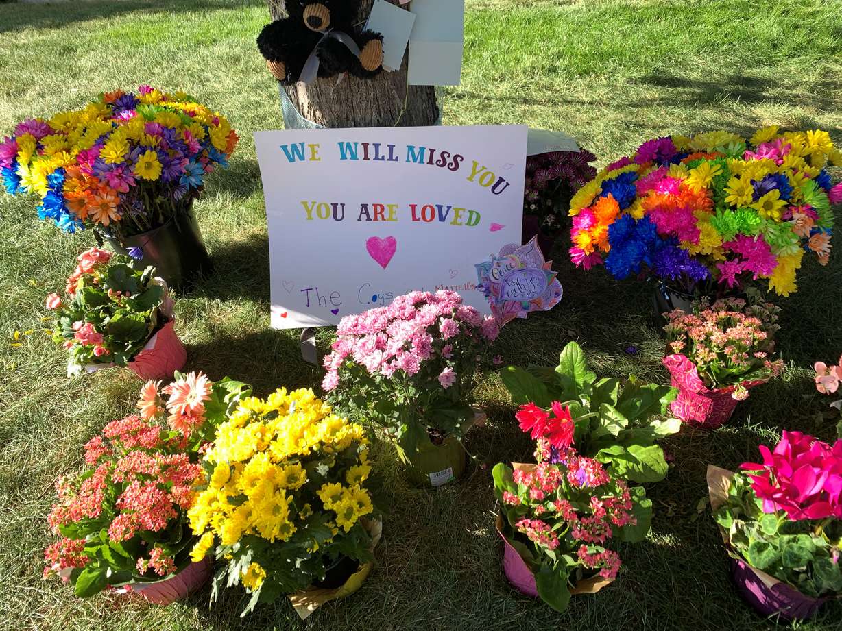 A memorial of flowers, cards, signs and gifts marks the home of Macie Hill, 8, who was killed in a tragic accident during the July 4th parade in Kaysville on Monday.