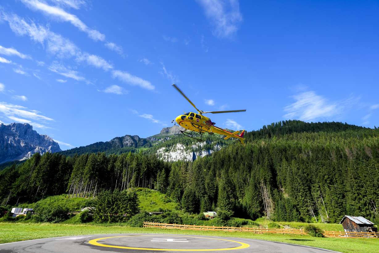 A rescue helicopter takes off to conduct searches for the victims of the Punta Rocca glacier avalanche in Canazei, in the Italian Alps in northern Italy, Tuesday, two days after a huge chunk of the glacier broke loose, sending an avalanche of ice, snow, and rocks onto hikers.